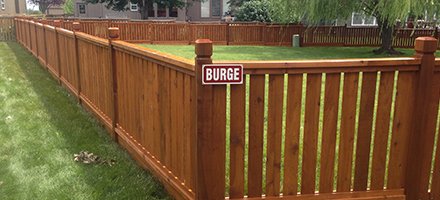 A view at the wooden fence with a badge burge on it.